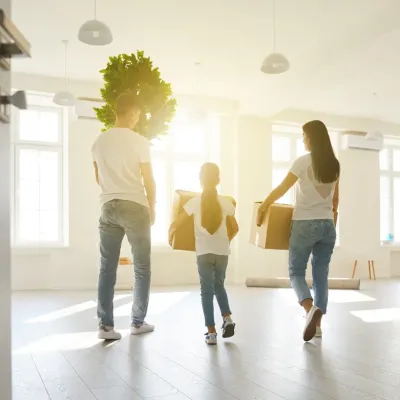 Une famille, cartons à la main, emménage dans leur nouveau logement.